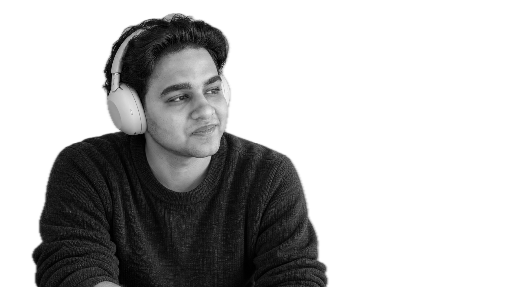 Tanish wearing headphones, looking to his left